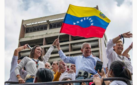 Opposition leader Maria Corina Machado and opposition presidential candidate Edmundo Gonzalez wave a Venezuelan Flag during a protest against the result of the presidential election on July 30, 2024, in Caracas, Venezuela. President of Venezuela Nicolas Maduro was declared as the winner of the 2024 presidential election over his rival, Edmundo Gonzalez. (Alfredo Lasry R/Getty Images/TNS)