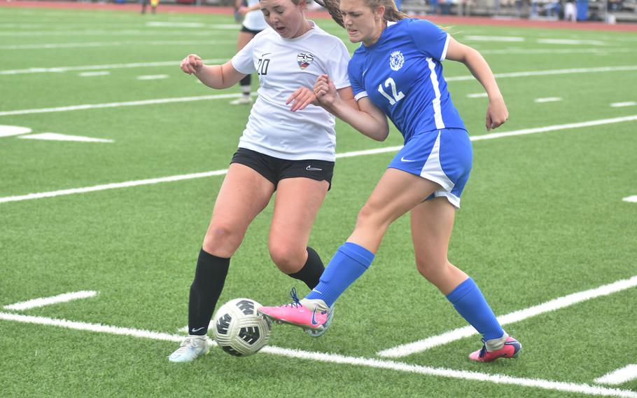 Stuttgart's Madeleine Fleming, left, and Ramstein's Kayla Groat battle for the ball Thursday, May 23, 2024, at the DODEA European Division I girls soccer championship game at Ramstein High School in Germany.