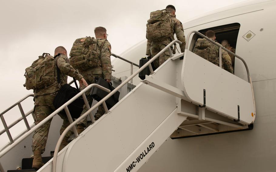 Soldiers from the 1st Battalion, 14th Field Artillery Regiment board a plan to Europe in May 2024.