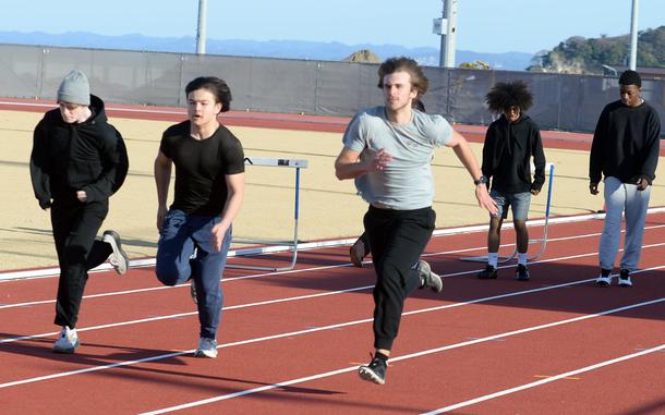 Nile C. Kinnick senior Nathan DeWolfe, grey shirt, and his teammates now have a track they can call their own on which to practice.