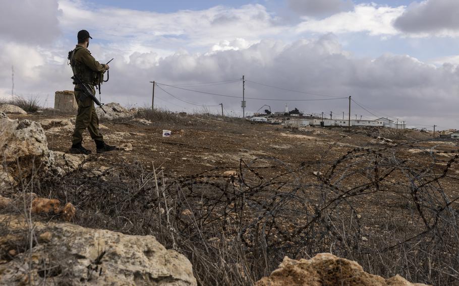 An Israeli soldier guards guard at Ahiya.