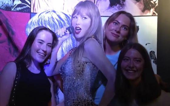 In this image taken from video, fans pose with a life-size image of Taylor Swift at a club that plays only Swift's music in Gothenburg, Sweden, on Tuesday, April 30th, 2024. Swift is scheduled to kick off the 18-city Europe leg of her record-setting Eras Tour on Thursday, May 9, 2024. There will be three shows in Stockholm.