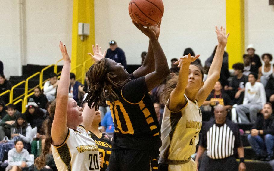 Kadena's Jayla Johnson pulls up for a shot between American School In Japan defenders. The Panthers rallied to win 30-24.