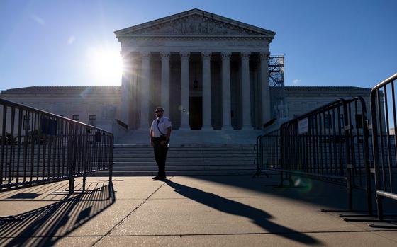A police officer stands near the security gate at the Supreme Court the day the court ruled on former president Donald Trump’s immunity claim.  