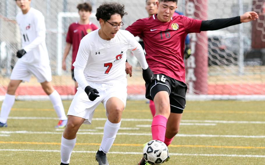 E.J. King's Amin Alipourkashki and Matthew C. Perry's Ren Spinosi battle for the ball during Saturday's DODEA-Japan boys soccer match. The Cobras blanked the Samurai 6-0.