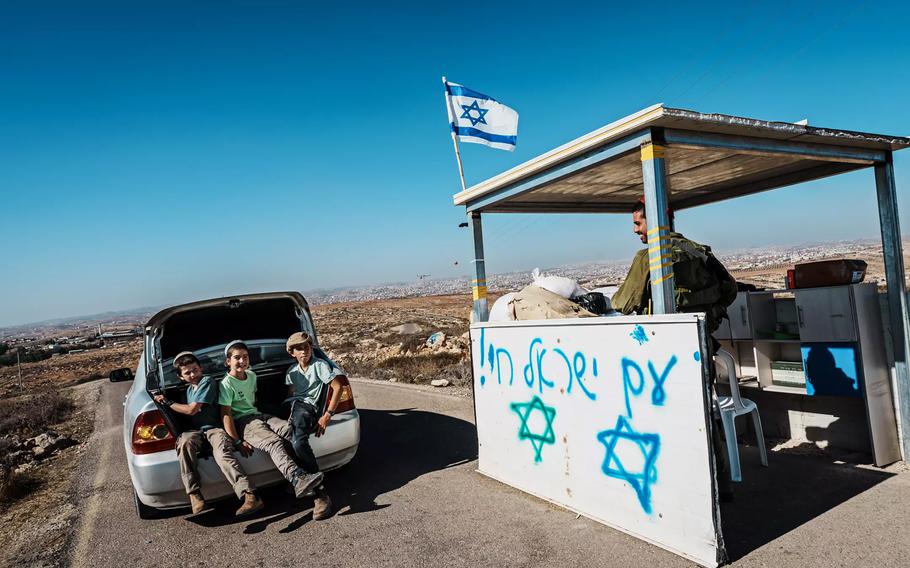 A vehicle passes by a checkpoint at the entrance to Mitzpe Yair, an Israeli settlement near the town of Susiya, in the occupied West Bank.