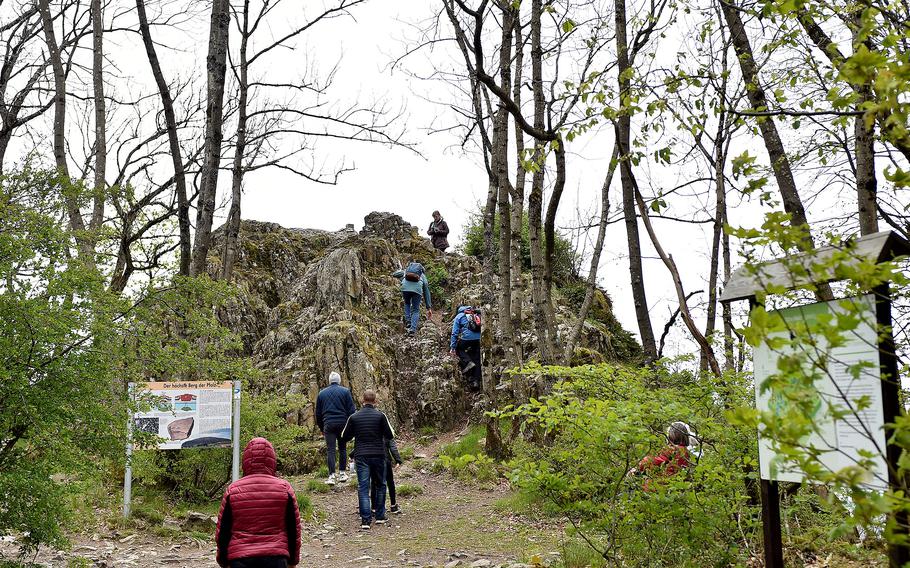 Hikers climb up the Königsstuhl on April 28, 2024. Composed of rhyolite, a silicia-rich volcanic rock, it sits at an elevation of 2,254 feet, making it the highest point in the Pfalz region of Germany.