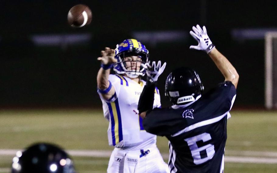 Yokota quarterback Josh Low tosses a pass by Zama defender Isaiah Segarra.