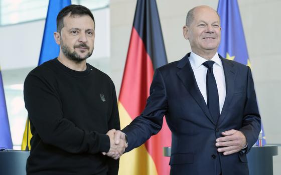 Ukraine's president Volodymyr Zelenskyy and German chancellor Olaf Scholz shake hands at the chancellery in Berlin, Germany, Friday, Oct. 11, 2024. (AP Photo/Ebrahim Noroozi)