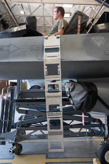 A prototype ladder for the F-16 Viper is draped over the side of the aircraft. The collapsible ladder is being tested at Aviano Air Base in Italy.