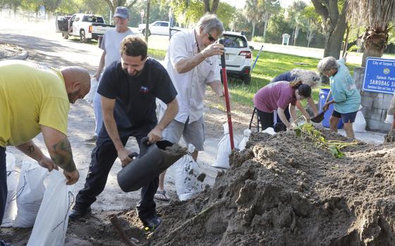 Resident help fill sandbags in Tarpon Springs, Fla., as they prepare their homes for potential flooding from approaching Tropical Storm Helene on Sep 24, 2024.