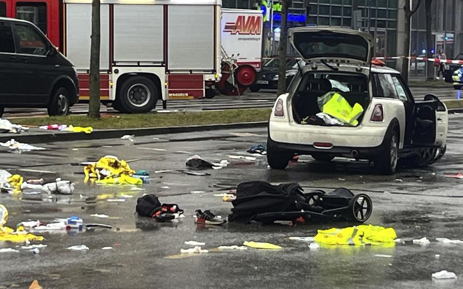 A stroller and debris litter the street where a driver hit a group of people in Munich.