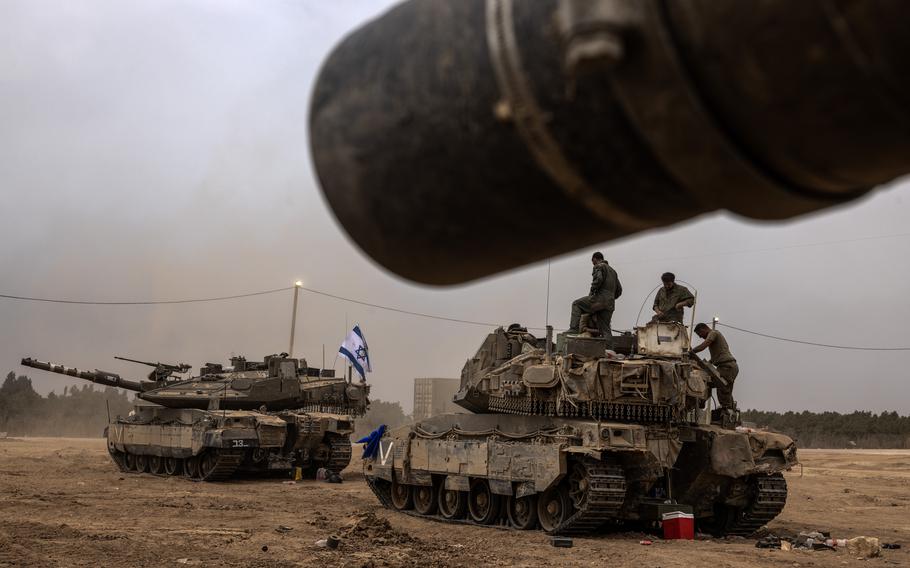 Israeli reservists stop at a military staging area