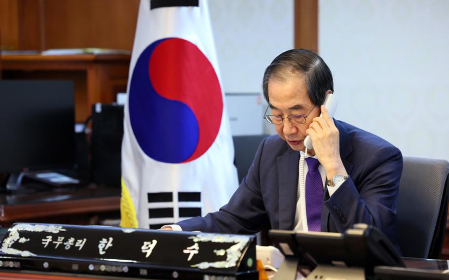 Han Duck-soo speaks to President Joe Biden by phone from his office in Seoul.