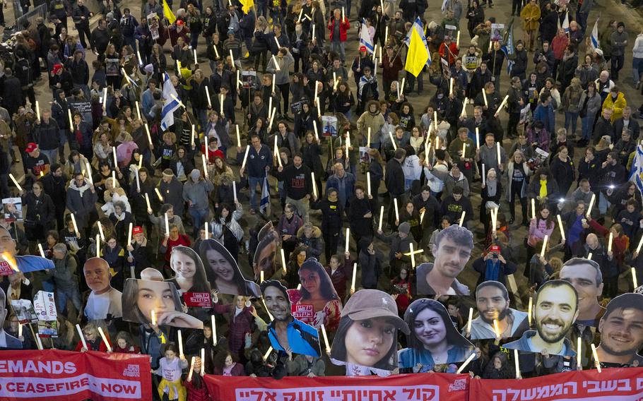 Protesters hold photos of hostages held in the Gaza Strip