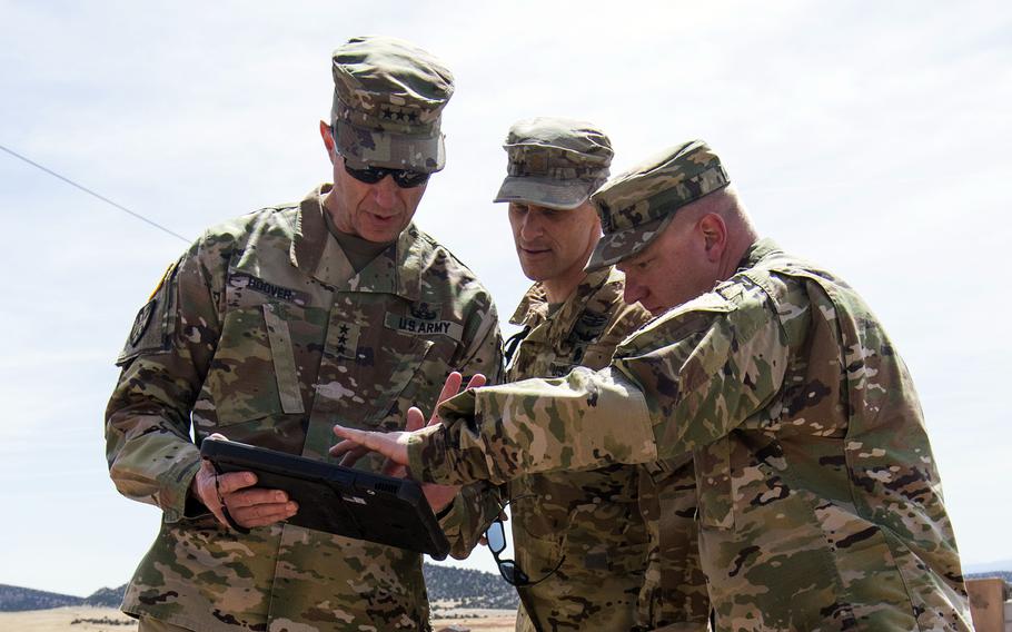 Then-Lt. Gen. Reynold Hoover, U.S. Northern Command deputy commander, Maj. Justin Douglas and Sgt. Maj. Brad Anderson, from left, review a digital X-ray of a simulated suspicious device from a scenario at an explosive ordnance disposal competition in 2018 at Fort Carson, Colo. Hoover is now the CEO for the 2028 Los Angeles Olympic and Paralympic Games.