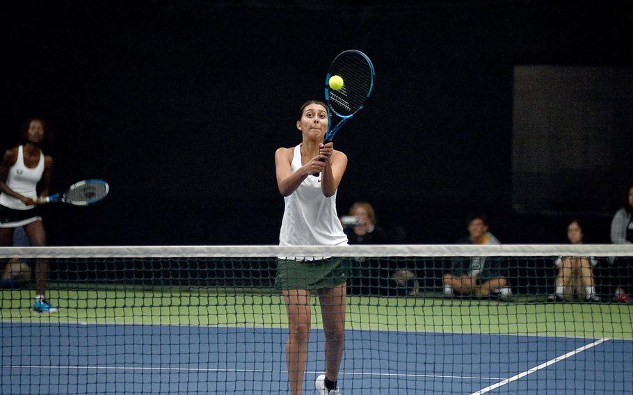 Naples' Aleczandria Rodriguez hits the ball at the net during a pool-play doubles match between her and teammate Andrea Mayounga and SHAPE's Chiara D'Arrigo and Maria Torrente during the DODEA European tennis championships on Oct. 20, 2023, at T2 Sports Health Club in Wiesbaden, Germany.