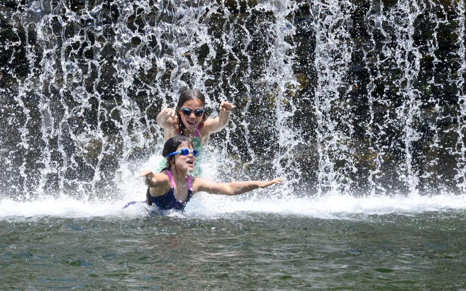Iris Murdie, 8 and her sister, Finoa, 10, play in the water at the Green River Timber Crib Dam in Guilford, Vt., on Wednesday, June 19, 2024.