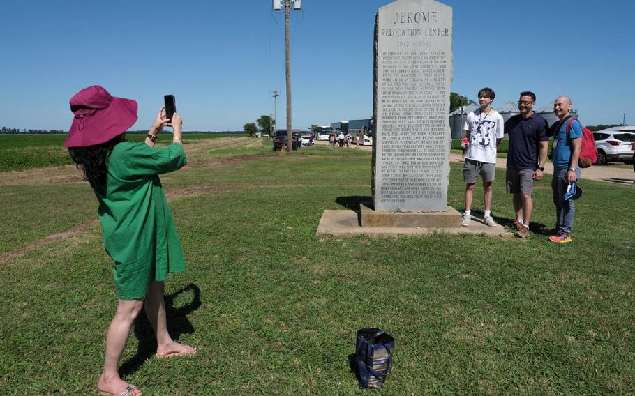 Juhu Thukra takes a photograph of Jackson, Scott and Jeffrey Yamaguchi on their first visit to the Jerome incarceration camp on June 6 in Arkansas. Their family members were incarcerated at the nearby Rowher incarceration camp during World War II.