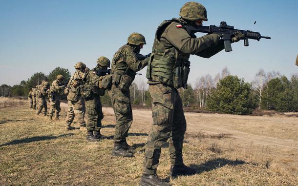 U.S. paratroopers assigned to the 3rd Brigade Combat Team, 82nd Airborne Division, and Polish soldiers engage targets during training in Nowa Deba, Poland, March 15, 2022. Poland expects to spend $200 million on upgrades for military bases used by U.S. forces during the next year.