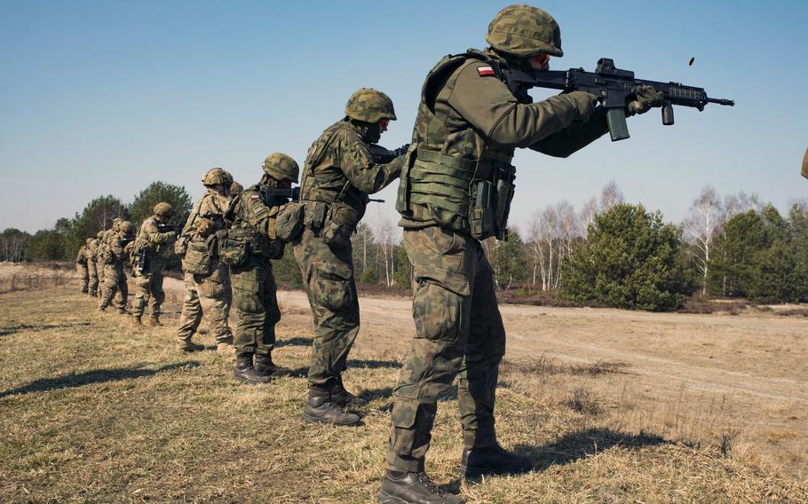 U.S. paratroopers and Polish soldiers engage targets during training.