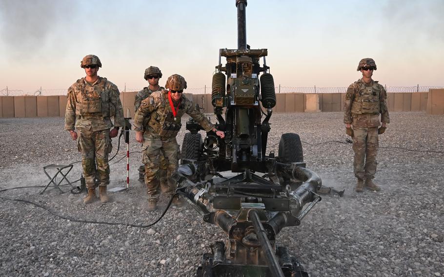 U.S. Army Chief Warrant Officer 3 Joseph Thigpen fires a 105 mm illumination round from the M119A3 Howitzer during a ceremony at al-Asad Air Base, Iraq, in January.