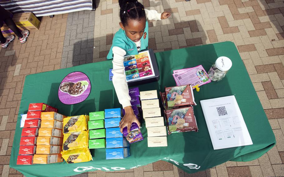 Junior Girl Scout Seleena Jackson, 10, restocks the cookies while waiting for customers outside the commissary on Marine Corps Air Station Iwakuni, Japan, in February 2023.