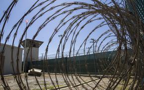 Razor wire and a control tower in Guantanamo Bay.