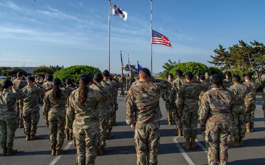 Members of the 8th Security Forces Squadron salute at Kunsan Air Base, South Korea, in May 2022.