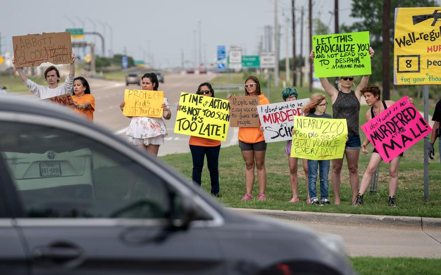 Protesters hold signs outside a prayer service on May 7 at Cottonwood Creek Church in Allen, Tex. MUST CREDIT: Photo for The Washington Post by Jeffrey McWhorter