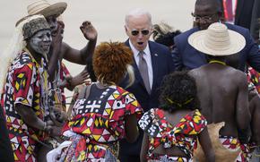 President Joe Biden watches a traditional dance after arriving at Catumbela airport in Angola on Wednesday, Dec. 4, 2024. (AP Photo/Ben Curtis)