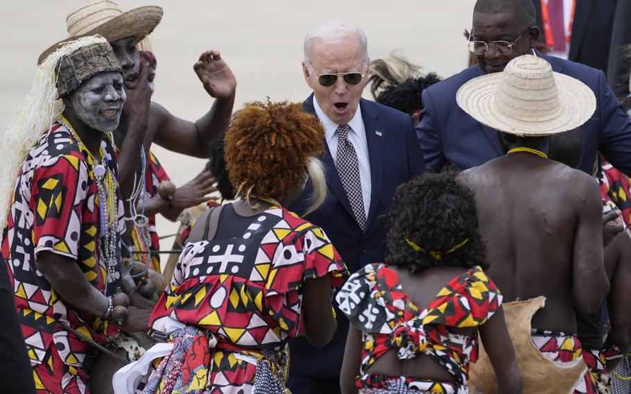 President Joe Biden watches a traditional dance after arriving in Angola.