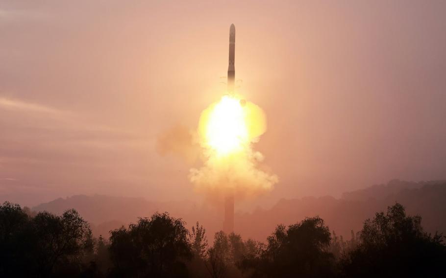 A ballistic missile launches up into the air with a fiery propulsion.