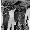 Aboard the USS Oriskany off the coast of Okinawa, June 28, 1955: Crew members of the USS Oriskany examine the crushed remains of the Banshee jet that crashed into the fantail of the attack aircraft carrier on June 22. The Navy Banshee - coming in for a landing that day - slid into the groove blinking its wing lights as it dipped for a landing. The landing signal officer with his electrically-lighted paddles began to guide it in – then hurriedly waved the paddles over his head as he saw the Jet sinking too low for a safe landing.
It was too late.
The jet flamed out. A wing dipped, and the Banshee, piloted by Lt. (jg) John R. Mitchell of Quincy, Mass. Plowed into the fantail at 125 miles an hour.
As high octane gas flamed into the night sky and the ship's fire crew ran to put them out, his fellow pilots gathered to remember Lt. Mitchell.
Then, the phone rang.

Read the 1955 eyewitness story of Lt. Mitchell's crash here.

Looking for Stars and Stripes’ historic coverage? Subscribe to Stars and Stripes’ historic newspaper archive! We have digitized our 1948-1999 European and Pacific editions, as well as several of our WWII editions and made them available online through https://starsandstripes.newspaperarchive.com/

META TAGS: U.S. Navy; aircraft carrier; F2H-2 Banshees; USS Oriskany; CVA-34; jet; accident; 