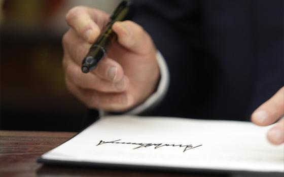 President Donald Trump signs executive orders in the Oval Office of the White House, Monday, Jan. 20, 2025, in Washington. (AP Photo/Evan Vucci)