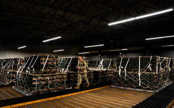 An airman checks the paperwork of pallets of ammunition, weapons and other equipment bound for Ukraine at a storage bunker at Dover Air Force Base in Delaware in 2022. MUST CREDIT: Demetrius Freeman/The Washington Post