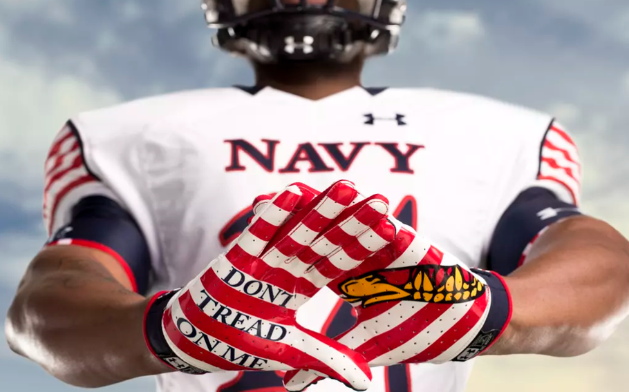 A Navy player holds out his hands. One glove says Don’t Tread on Me, the other has a serpent.