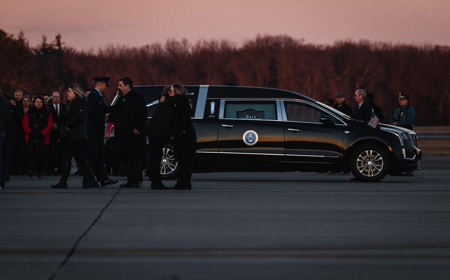 Families and friends console each other after receiving the remains of U.S. Air Force Staff Sgt. Jacob Galliher, killed in a training accident in Japan, at Westover Air Reserve Base, Friday, Dec. 15, 2023.