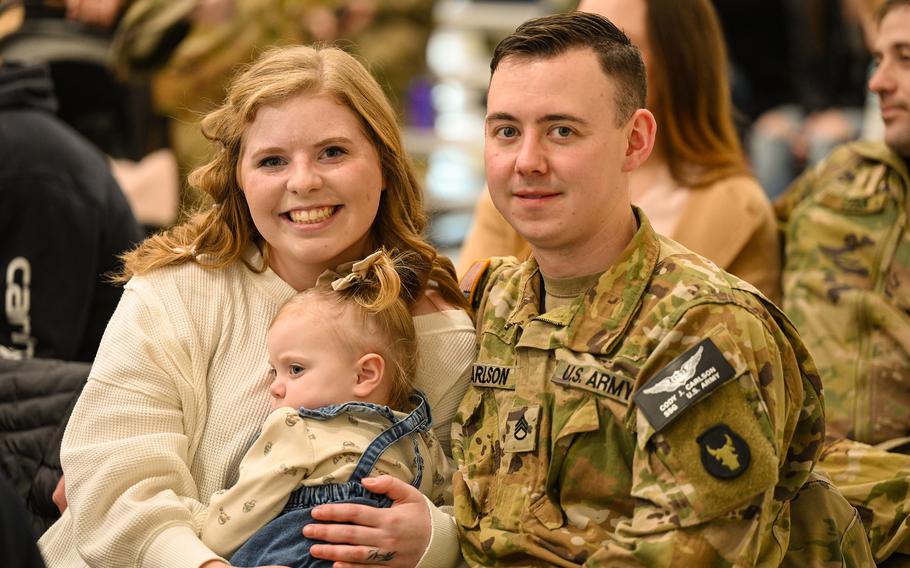 A soldier and his family pose for a photo