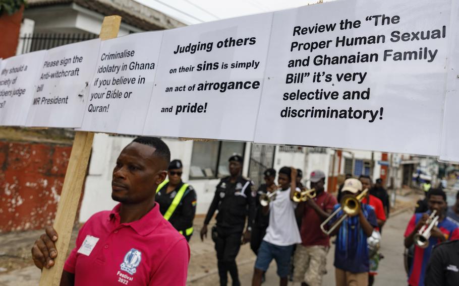 Texas Kadri Moro, executive director of Arise for Justice International, protests with placards nailed to a cross on the street in Accra, Ghana.