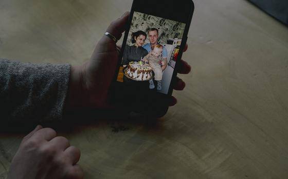 A photo of a family is shown on a cellphone.