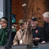 World War II veteran Dennis Bolt throws nuts to a crowd as part of the annual Battle of the Bulge commemorations in Bastogne, Belgium, Dec. 14, 2024. He is joined by Belgium's Queen Mathilde, left, and King Philippe, far right. 