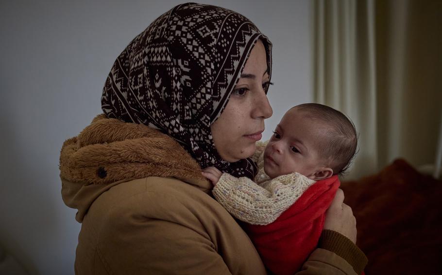 Hala Arouq holds her daughter, Massa, in the neonatal unit after they were reunited in Egypt. 