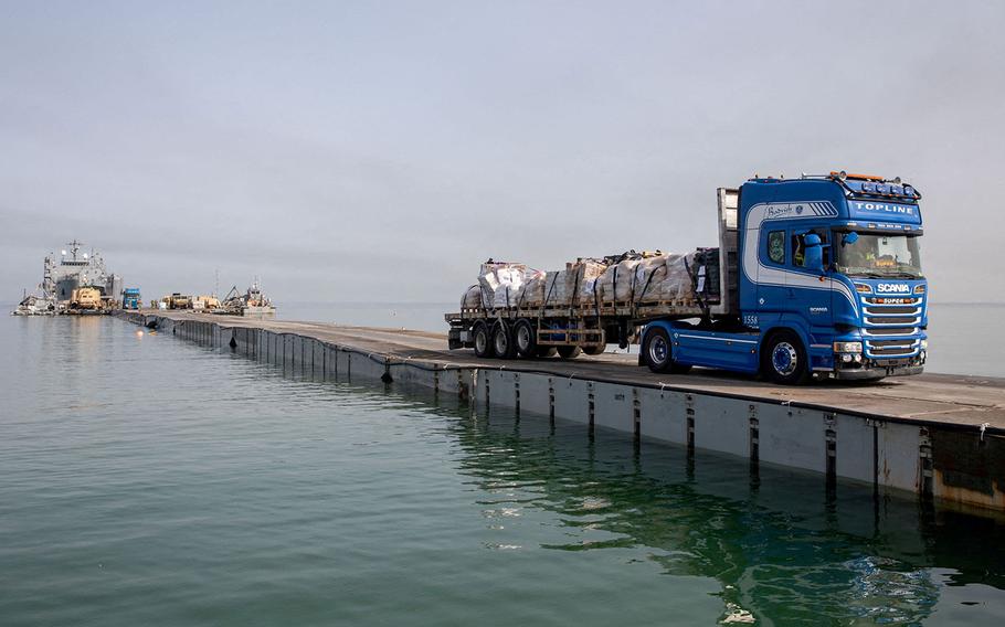 A truck carries humanitarian aid across Trident Pier, a temporary pier to deliver aid, off the Gaza Strip, amid the ongoing conflict between Israel and the Palestinian Islamist group Hamas, near the Gaza coast, May 19, 2024. 