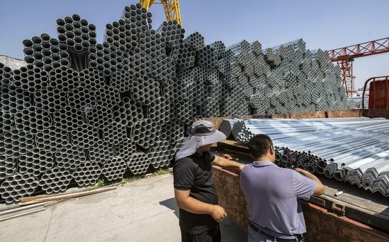 Bundles of steel tubing at a trading market last month in Jinan, China. China's steel exports have swelled, prompting a backlash overseas as some economies impose higher tariffs. MUST CREDIT: Qilai Shen/Bloomberg