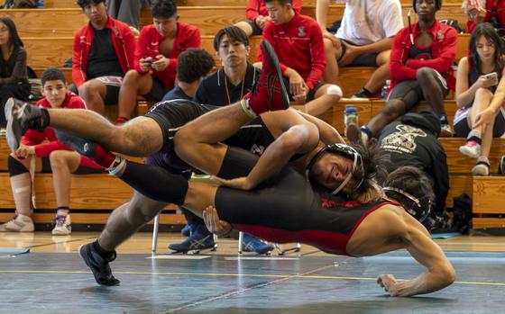 Zama's Isaiah Segarra gets the upper hand on Kinnick Red's Joseph Mauldin.