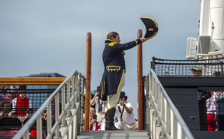 Cmdr. Crystal L. Schaefer, commanding officer of USS Constitution, salutes the ensign as she boards for a turnaround cruise to celebrate Independence Day on Thursday, July 4, 2024. 