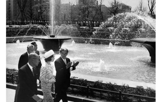 Tokyo, Japan, Apr. 10, 1961: Princess Michiko admires a fountain built in front of the Tokyo Imperial Palace in honor of her second wedding anniversary. Shigeo Mizuno (right), president of the Sankei Newspaper to Tokyo, explains the fountain's operation to the princess. Crown Prince Akihito was unable to accompany her to dedication ceremonies Monday due to illness. The royal couple were married two years ago. The fountain has three pedestals spraying water continuously into a pool, 109 feet long and 60 feet wide. Construction costs were covered by a memorial fund begun by the Japanese people when the prince and princess were married.

Looking for Stars and Stripes’ historic coverage? Subscribe to Stars and Stripes’ historic newspaper archive! We have digitized our 1948-1999 European and Pacific editions, as well as several of our WWII editions and made them available online through https://starsandstripes.newspaperarchive.com/

META TAGS: Imperial House of Japan; Imperial family; Yamato Dynasty; Michiko Shoda; Japanese culture; anniversary; royalty
