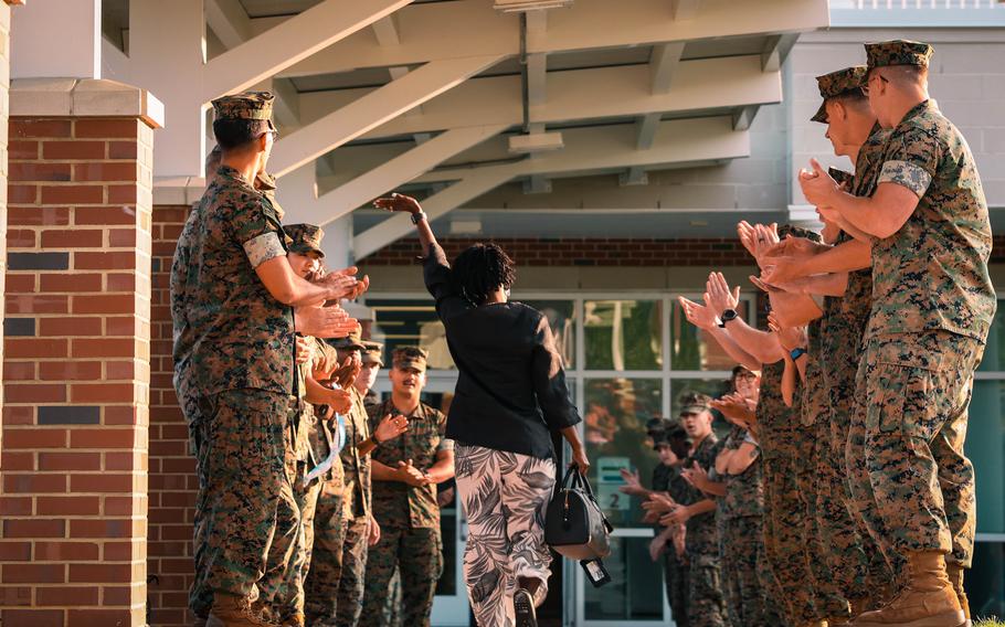 U.S. Marines cheer for a teacher during a back-to-school celebration at the Crossroads Elementary School on Marine Corps Base Quantico, Va., Aug. 21, 2024. 