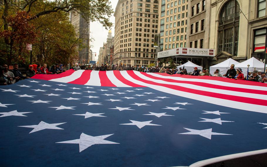 The American flag is carried by parade attendees during the New York City Veterans Day Parade on Nov. 11, 2022. Veterans living in historically segregated neighborhoods experienced higher risks of heart attacks and strokes, according to a study published July 11, 2023, in the Journal of the American Medical Association. 